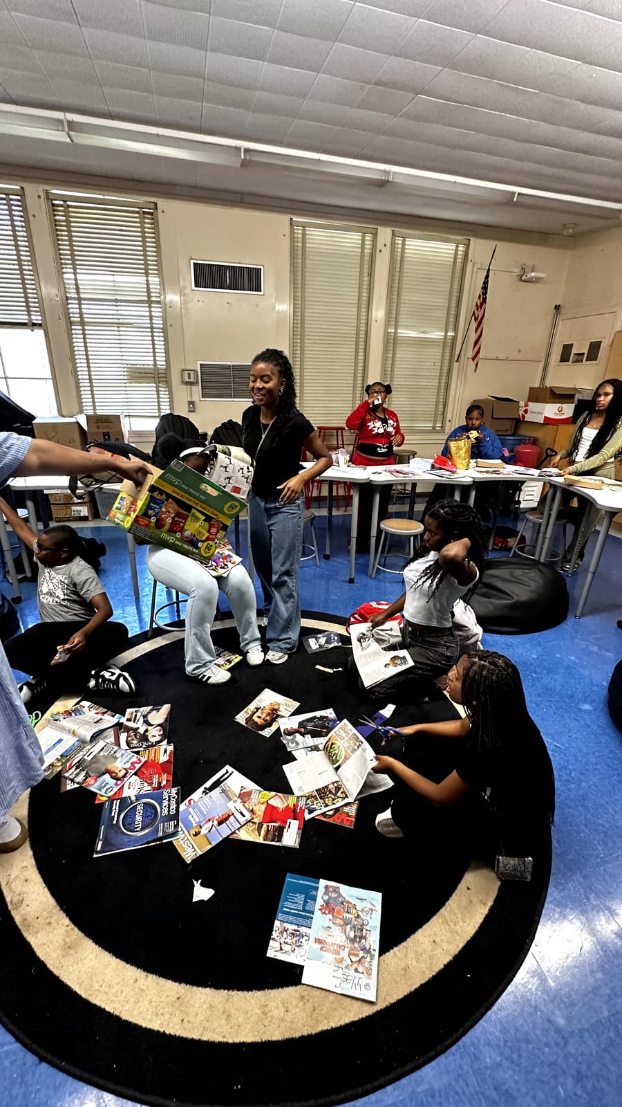 Students cutting magazine clippings for a vision board activity